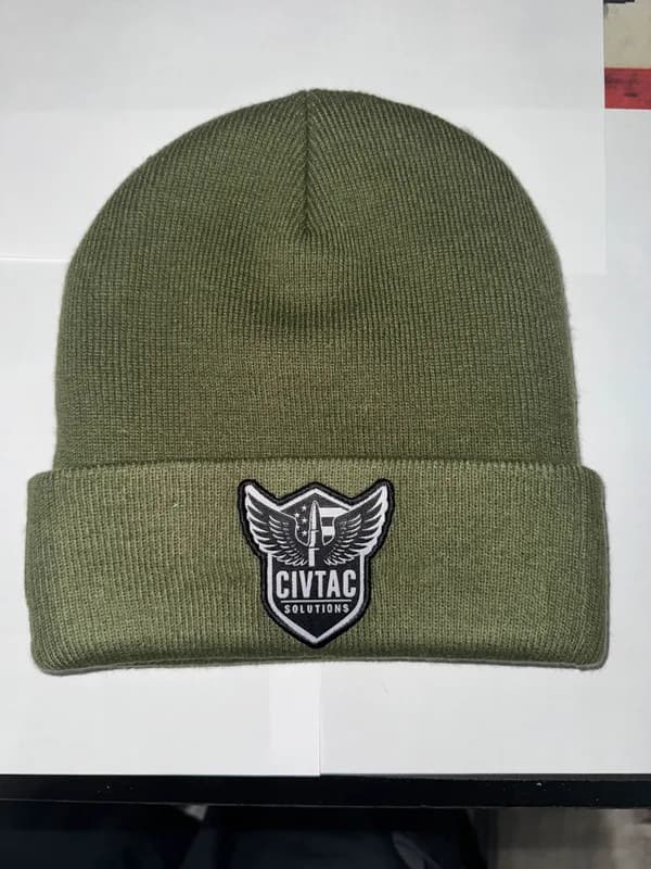 The raw photo of a CIVTAC beanie, taken on a desk